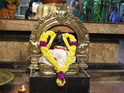 God Ganesh in front of the Kodi Thambam (where the flag is tied during the annual festival of the temple) is decorated with fresh flowers and Golden border vetti