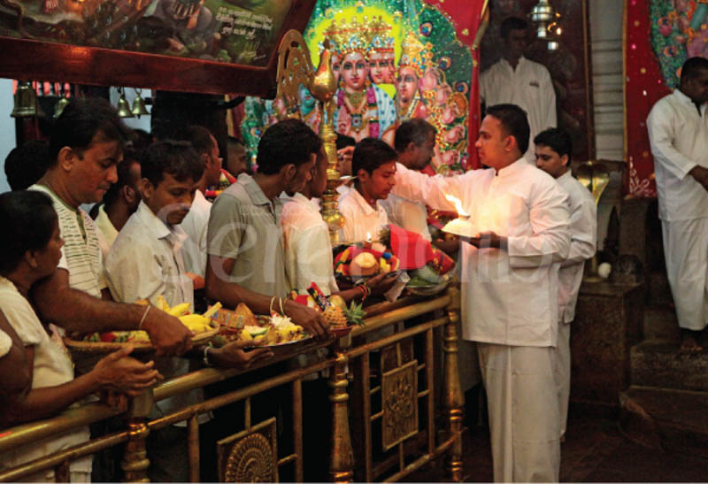 Placing vibhuti or holy ash on the forehead of the devotees as a blessing