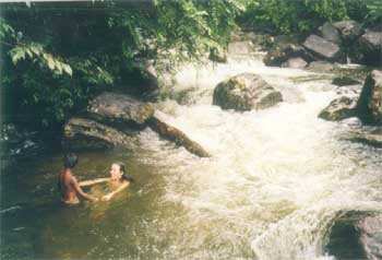 Author bathing in nearby stream with children
